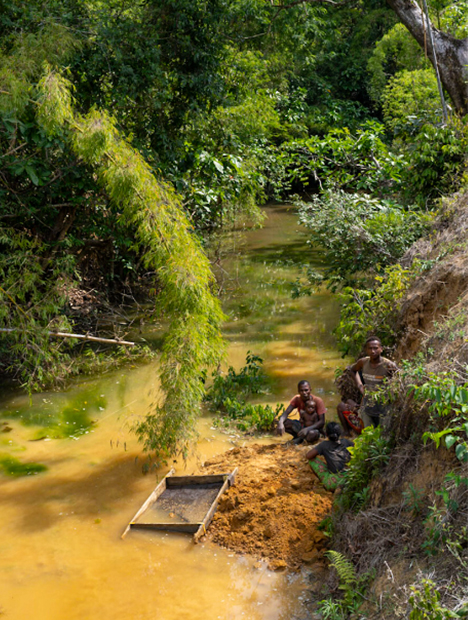 Three miners by river in Madagascar.