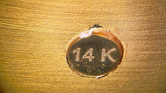Figure 2. The hallmark is not actually stamped onto the metal but is on a separate disk adhered to the inside of the bracelet. Photo by Rambod Bahadory.