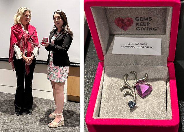 Left: Gabriela Farfan (right), Coralyn W. Whitney curator of gems and minerals for the Smithsonian National Museum of Natural History, accepts the original Gems Keep Giving pin from Hayley Henning, chairperson of the organization. Right: The original prototype pin featuring a Montana sapphire. Photos by Jennifer Stone-Sundberg. Left: Gabriela Farfan (right), Coralyn W. Whitney curator of gems and minerals for the Smithsonian National Museum of Natural History, accepts the original Gems Keep Giving pin from Hayley Henning, chairperson of the organization. Right: The original prototype pin featuring a Montana sapphire. Photos by Jennifer Stone-Sundberg.