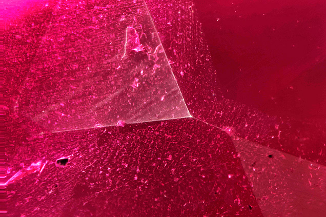 Synthetic ruby overgrowth on natural sapphire seed.