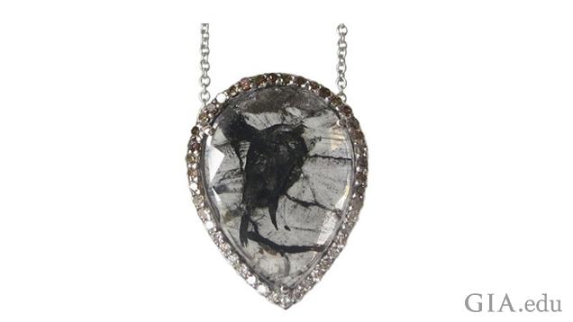 A 4.10 ct colorless diamond “slice” pendant with black inclusions set in white gold and surrounded by colorless to brown pavé diamonds by Rachel Boston, London. Photo courtesy Rachel Boston