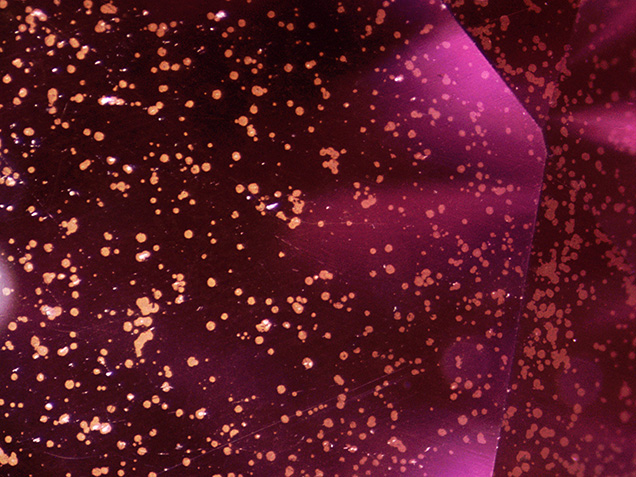 Metallic flakes on the surface of the synthetic moissanite