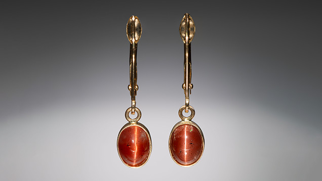 Figure 1. Cat’s-eye labradorite earrings set in 14K gold. The stones measure 7 × 5 mm. Photo by Kevin Schumacher; courtesy of Ben Kho Gems.