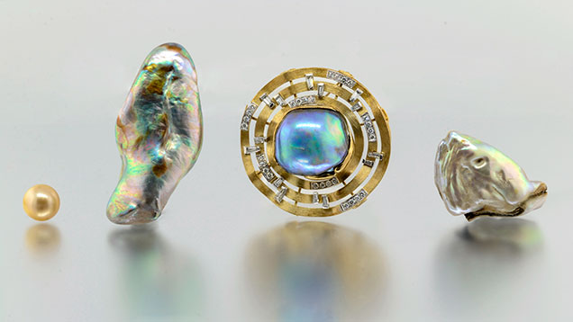 Three abalone pearls alongside South Sea bead-cultured pearl.