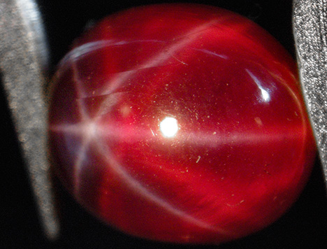 Synthetic ruby with white star and orange-red star