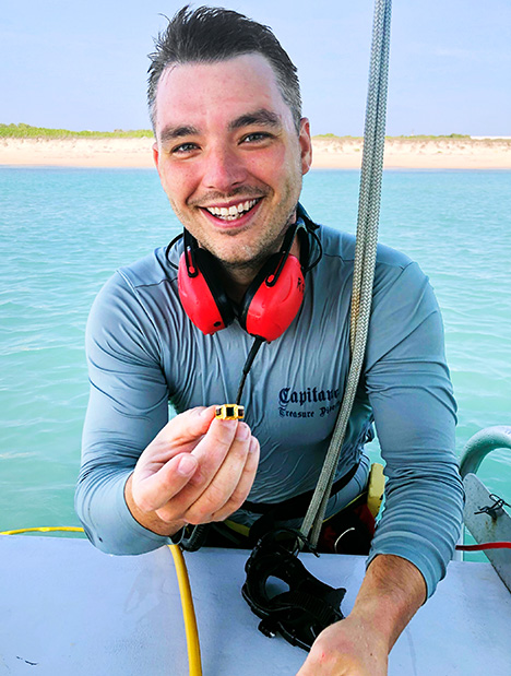 Figure 1. Captain Grant Gitschlag holds an amethyst and emerald ring recovered from the 1715 Spanish shipwreck (also shown in figure 3). Photo courtesy of 1715 Fleet Queens Jewels.