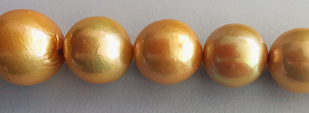 Uneven color and blemishes on low-quality cultured pearl necklace.