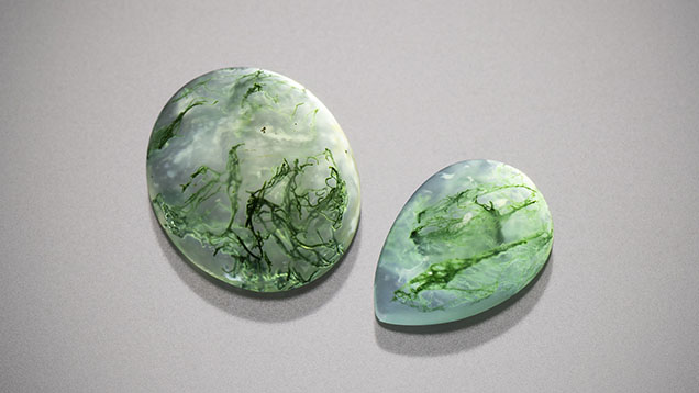 Figure 9. Moss agate cabochons measuring 12 × 10 mm (left) and 10 × 7 mm (right). Photo by Kevin Schumacher; courtesy of Columbia Gem House.