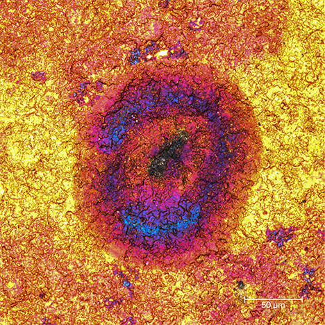 Pink and blue zones, impurity center within a gold tarnish spot