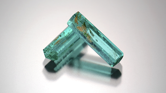 Two glass prisms imitate Paraíba tourmaline crystals.