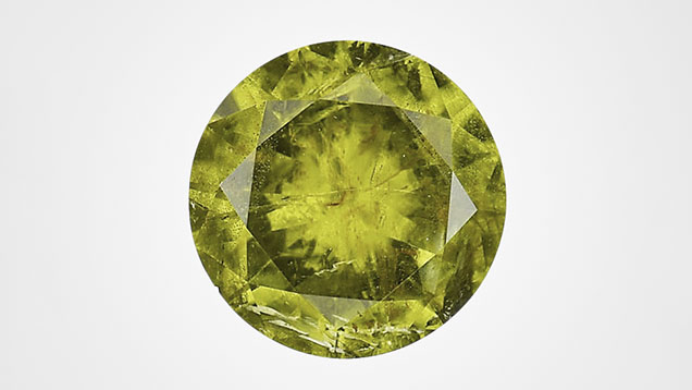 Figure 1. The face-up view of a 2.32 ct faceted pallasitic peridot, the largest extraterrestrial peridot seen at GIA to date. Photo by Diego Sanchez.