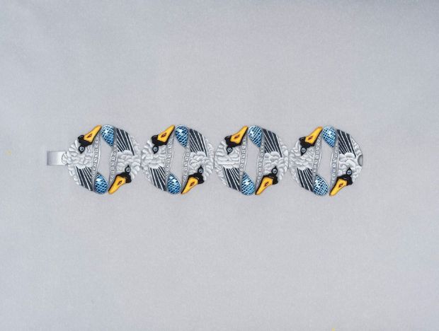 <strong>2022 Winner</strong> Design by Sara Guergova, a graduate of the GIA Jewelry Design course in London, UK – “Swans represent togetherness and loyalty, and during the time of designing this bracelet, I felt those themes needed to shown the most.”. The bracelet design features gold, diamond, ruby, sapphire, tourmaline, onyx and enamel.