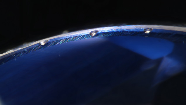 Laser ablation spots on girdle of a synthetic sapphire