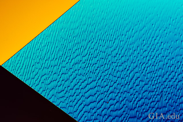 “Lizard skin” results from polishing a facet that lies nearly parallel to the octahedral face, which is the hardest crystal direction in diamond. Field of view 0.72 mm.