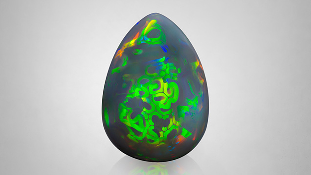 Figure 1. A natural 47.77 ct Ethiopian opal with an unusual play-of-color pattern. Photo by Nuttapol Kitdee.