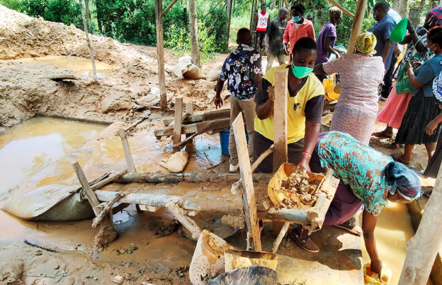 Miners use a sluice to collect gold.