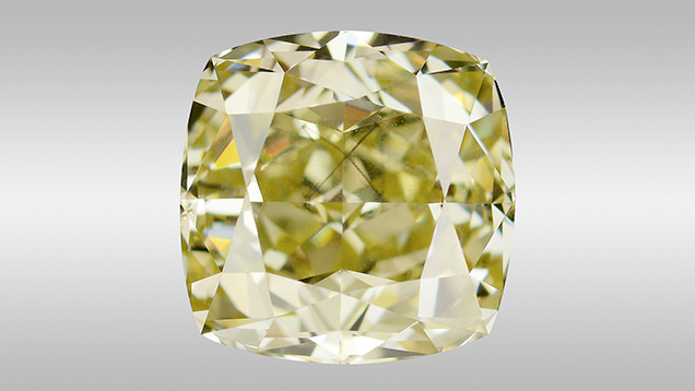 Fancy brownish greenish yellow diamond with octahedral-shaped inclusion.