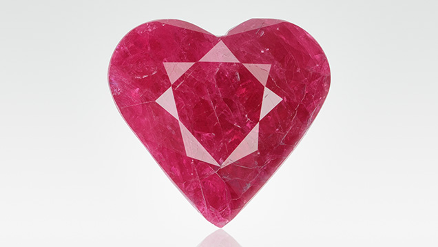 Figure 1. An 8.57 ct heart-shaped fracture-filled ruby treated with a zinc glass filling. Photo by Adriana Robinson.