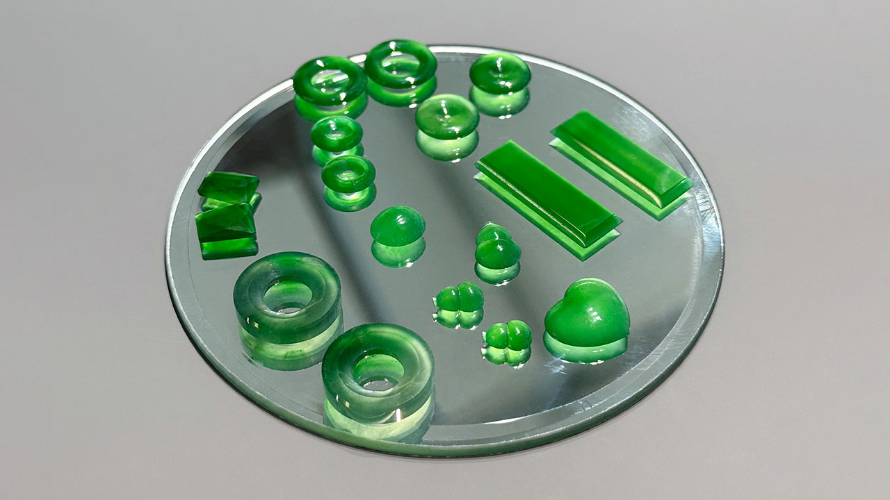 Figure 2. Several Guatemalan jade pieces placed on a mirror to demonstrate the transparency of the material. Photo by Jennifer Stone-Sundberg; courtesy of Pillar & Stone.