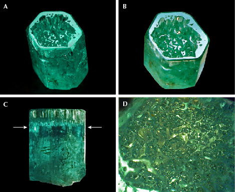Figure 16. A: Sample 16 (10.8 mm in length), an emerald crystal developed in the form of a cup. B: The basal plane of the cup reflects together with the basal faces of small hillocks or columns in the cup. C: The bottom of the cup is located in the upper half of the crystal, as indicated by arrows. D: Framework of irregular hillocks, columns, and walls on the bottom of the cup in a view parallel to the <em>c</em>-axis. Photos by G. Martayan (A) and K. Schmetzer (B–D); field of view 4.6 mm (D).