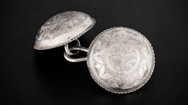 Figure 7. A set of intricately engraved silver cloak buttons. Photo by Emily Lane.