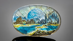 Left: A sci-fi scene in this oval measuring 48 × 72 × 8 mm and weighing 247 ct depicts streaks of light filtering through pine forests and reflecting in the lakes below. At the horizon, a giant moon emerges from behind the mountains. Photo by Robert Weldon. Right: Detail of variations in the perceived color, depending on the orientation of the light source. Photomicrograph by Nathan Renfro.