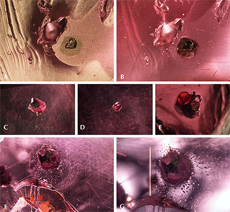 Surface-reaching sulfide crystal in “color-change” pyrope garnet