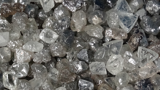 A close-up image of a pile of rough diamonds.