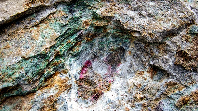 An outcrop of ruby-bearing micaceous lenses within marble in Snezhnoe, Tajikistan.