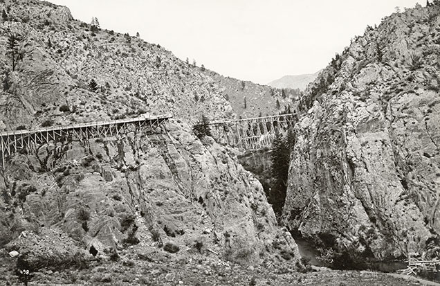 Figure 8. The flume taking water from Trout Creek to the sapphire and gold mining operations at the Missouri River. In this view, the flume is crossing Trout Creek itself, with the water taken from further upstream. Photo by W.H. Jackson during the 1869–1871 Hayden Survey. Lot 032 B5F09.03a Trout Creek Flume, Montana Historical Society Photograph Archives.