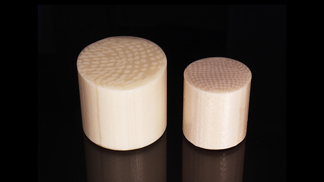 Two resin imitation ivory materials show parallel linear striations.