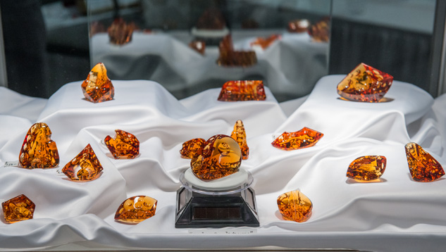 Citrine carvings by gem designer Michael Dyber adorn a showcase at a Tucson gem show. - Eric Welch, courtesy Michael Dyber