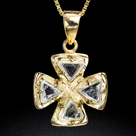 Figure 14. A gold pendant adorned with four flattened triangular macle rough diamonds with re-entrant corners belonging to morphology groups III and IV, weighing 0.945 total carats. Photo by Tetsuya Chikayama.