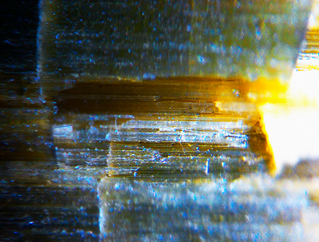 Parallel striations and tube-like inclusions.