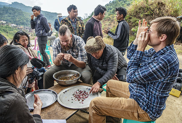 Figure 2. Besides gemological and geologic aspects, the practice of field gemology allows gemologists to understand the culture, political dynamics, and trade complexities related to gemstones. Here field gemologists Wim Vertriest (seated center) and Aaron Palke (seated right) examine rough material from Wa Khan Sho, near Mogok, which produces ruby, sapphire, and spinel. Photo by Robert Weldon.