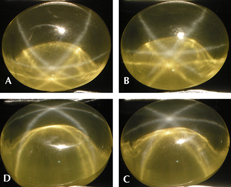 Yellow synthetic sapphire with a white star and a yellow star, shown with rotation of the cabochon