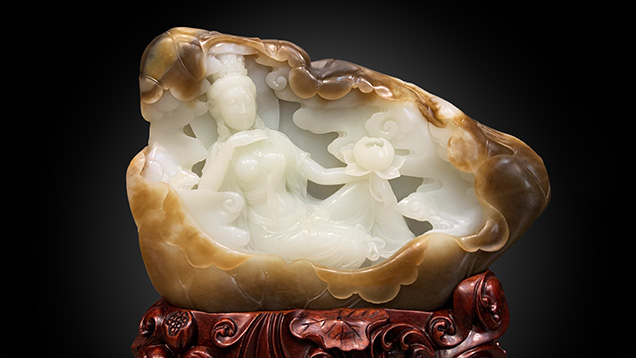 Figure 17. A Russian white nephrite carving depicting a woman holding a lotus flower, measuring approximately 30 × 19 × 5 cm. Photo by Yu Ming.