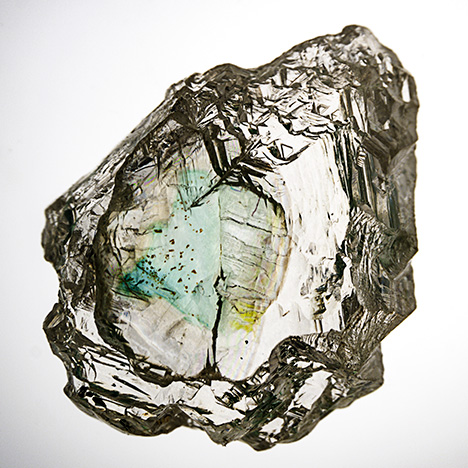 Rough diamond with green coloration along internal cleavage.