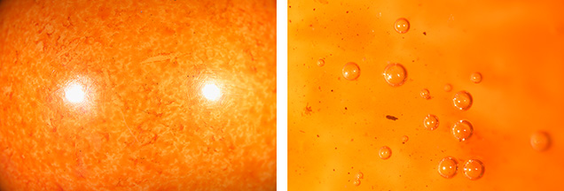 Figure 3. Microscopic observation of the 89.81 ct sphere revealed unnatural color patches (left) and gas bubbles and trapped dirt (right). Photomicrographs by Ravenya Atchalak; fields of view 19.20 and 1.80 mm.