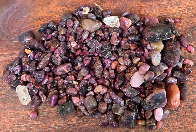 Figure 1. A handful of gem gravel collected from the Lofa River in Weasua, Liberia, showing the high concentration of ruby material. Photo courtesy of Diamonds for Peace.