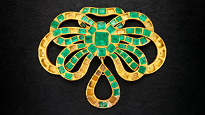 Figure 2. This gold and emerald pendant contains 61 Colombian emeralds with 33 stones missing, presumably lost during its residence on the seafloor for more than 300 years. The pendant is approximately 3.5 in. (8.9 cm) wide. Photo by Emily Lane.