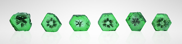 Six emerald wafers displayed a trapiche-like pattern.