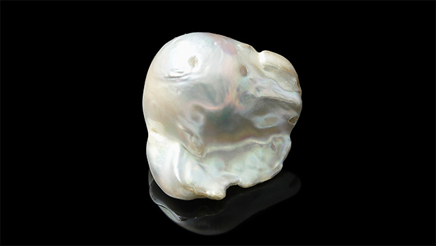 This 20.60 ct specimen was purchased by the client as a “natural white pearl.”