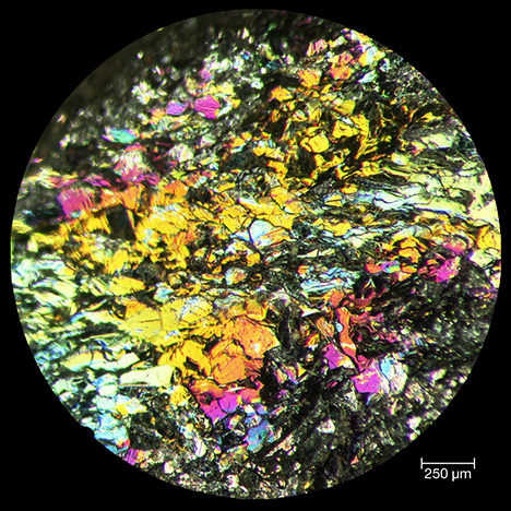 Reflected light microscope image of iridescent hematite.