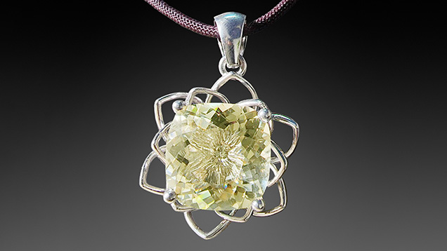 Figure 11. This 25.99 ct light yellow anorthoclase (sample AF1) is set in a 14K gold pendant. Photo by Le Ngoc Nang.