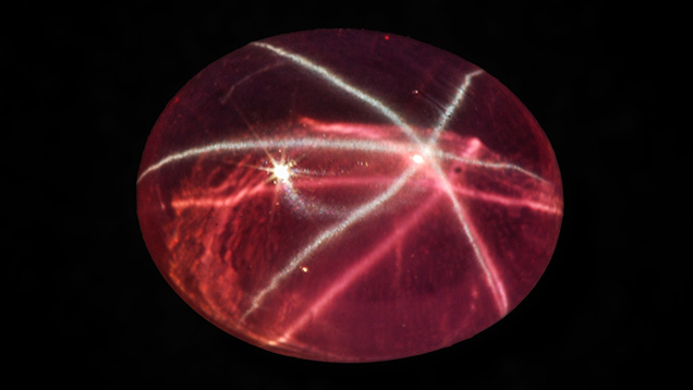 Pink synthetic sapphire with white star and pink star