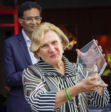 Susan Jacques accepts the Richard T. Liddicoat Award for Distinguished Achievement while incoming GIA president and CEO Pritesh Patel looks on. Photo by Russel Samson.