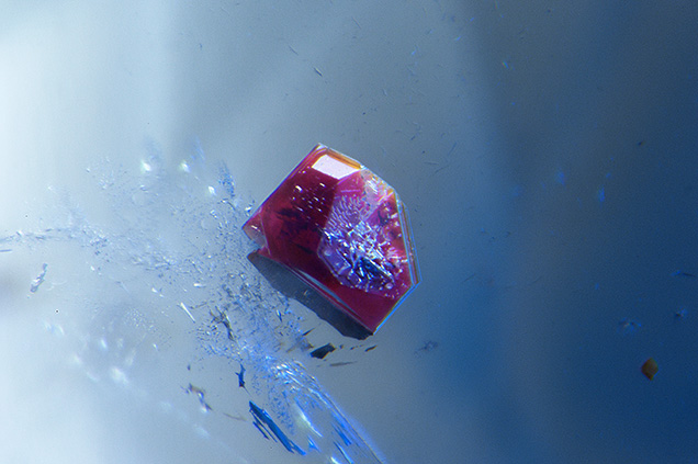Small reddish brown neptunite inclusion in benitoite host.