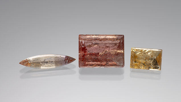 Figure 7. Imperial topaz with schiller: 1.51 ct, 7.89 ct, and 2.48 ct from left to right. Photo by Kevin Schumacher; courtesy of Jennifer Stone-Sundberg.