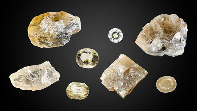 Figure 1. Yellow, brownish gray, and near-colorless anorthoclase feldspar from southeast Vietnam. The rough stones range from 96.5 to 144.8 ct and the cut samples from 3.64 to 11.07 ct. Photos by Le Ngoc Nang.